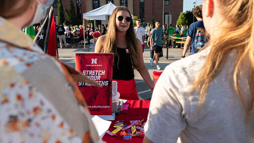 Students talking to a vendor at a table