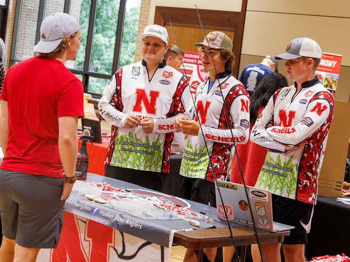 Members of the Husker Bass Angler Club RSO speak with a student during the Nvolvement Fair at East Campus, August 2024.